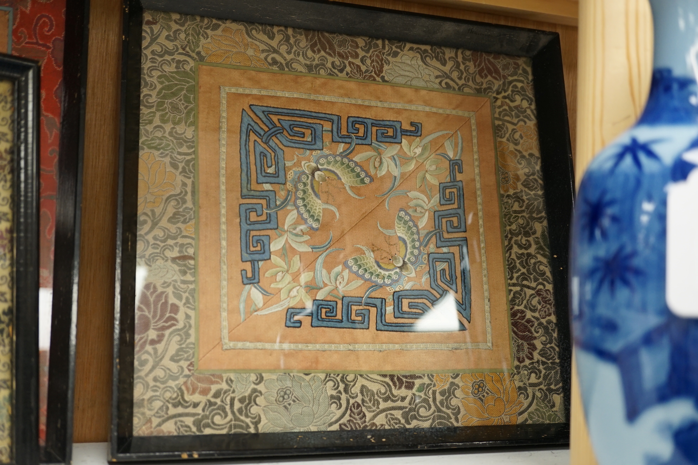 Three framed Chinese silk embroidered panels including a Beijing knot embroidered panel, two with applied butterflies, largest frame 31cm x 31cm